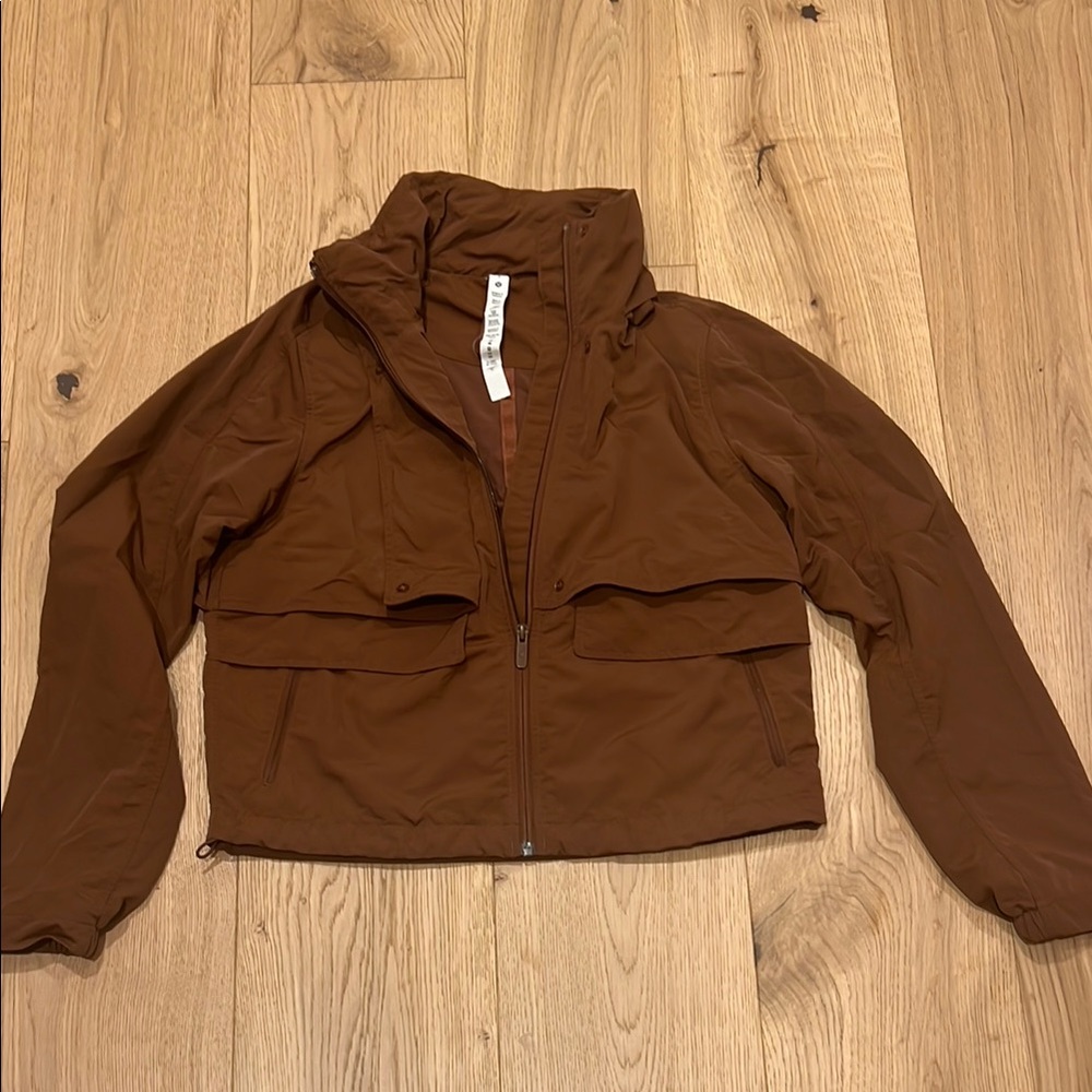 Lulu Lemon Brown Rain Jacket with Collapsible Hood High Collar and Relaxed Fit